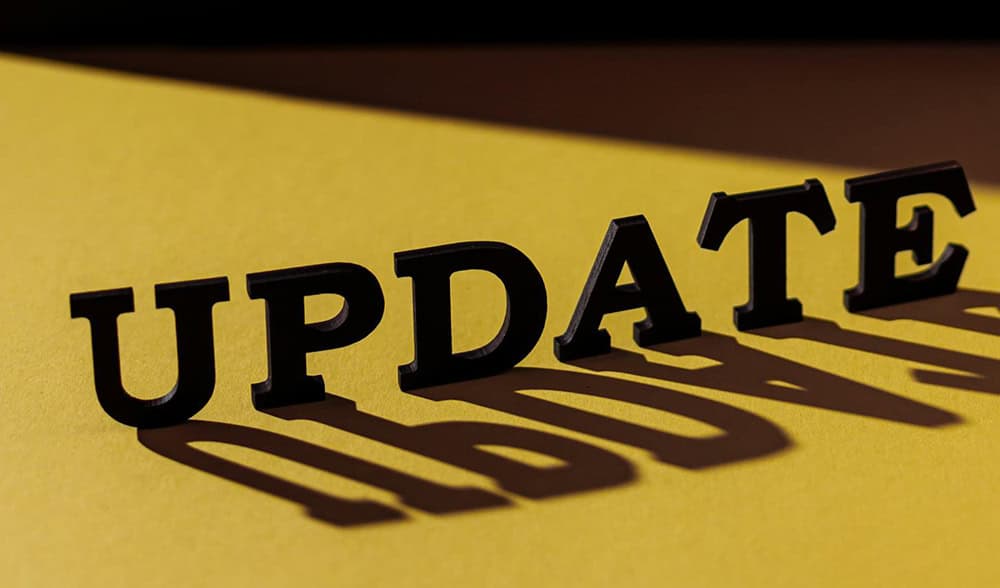 The words UPDATE stand boldly in black, casting a shadow on a yellow surface, much like the impact of a reciprocal tariff shaping global trade dynamics.